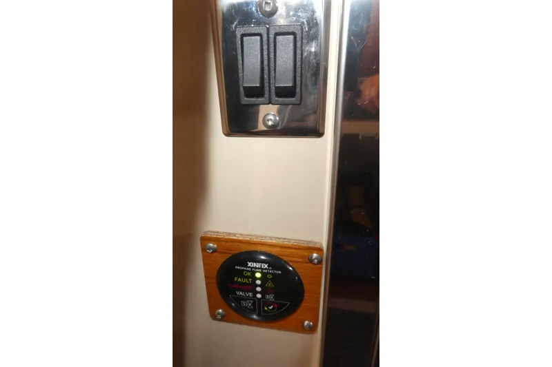 Slide: The Image of Control panel on 2019 Ranger Tugs R-27 boat with switches and indicators. - 36