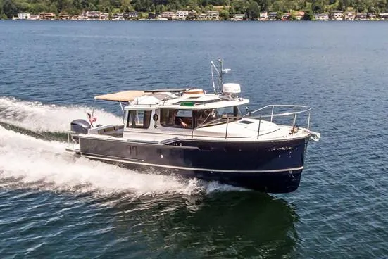 Slide: The Image of Manufacturer Provided Image: 2019 Ranger Tugs R-27 cruising on a lake with houses in the background. - 9
