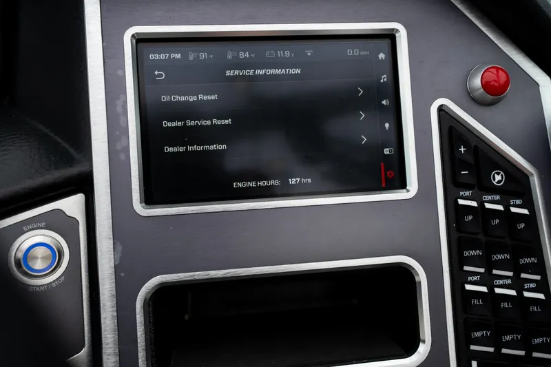 Slide: The Image of 2023 MasterCraft XT24 dashboard displaying service information and engine hours. - 18