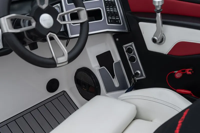 Slide: The Image of 2023 MasterCraft XT24 boat interior with steering wheel and control panel. - 33