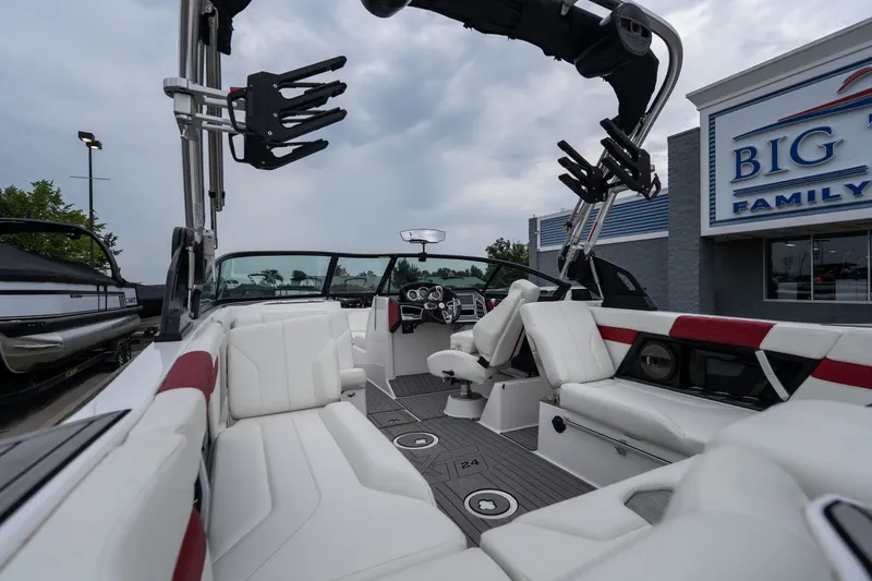 Slide: The Image of 2023 MasterCraft XT24 boat interior with white seating and modern dashboard. - 14