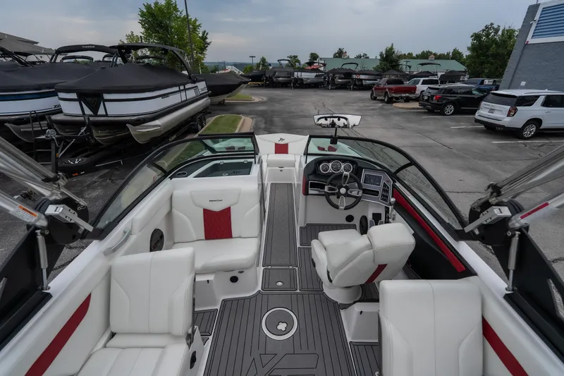 Slide: The Image of 2023 MasterCraft XT24 boat interior with white seating and modern dashboard. - 36