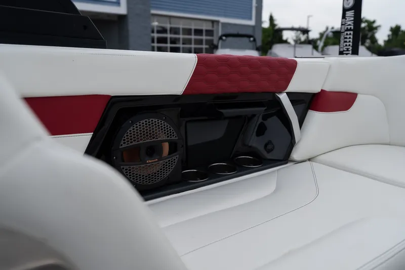 Slide: The Image of 2023 MasterCraft XT24 interior with red and white upholstery, featuring a built-in speaker system. - 25