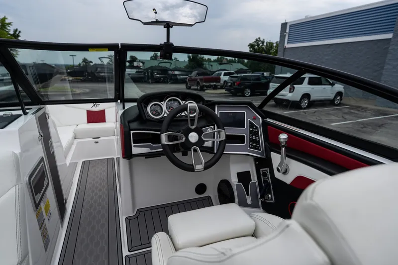 Slide: The Image of 2023 MasterCraft XT24 boat interior with modern dashboard and steering wheel. - 15