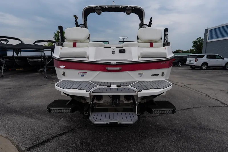 Slide: The Image of 2023 MasterCraft XT24 boat rear view with swim platform and seating. - 38