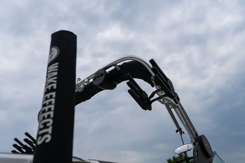 Slide: The Image of 2023 MasterCraft XT24 wakeboard tower against cloudy sky. - 40