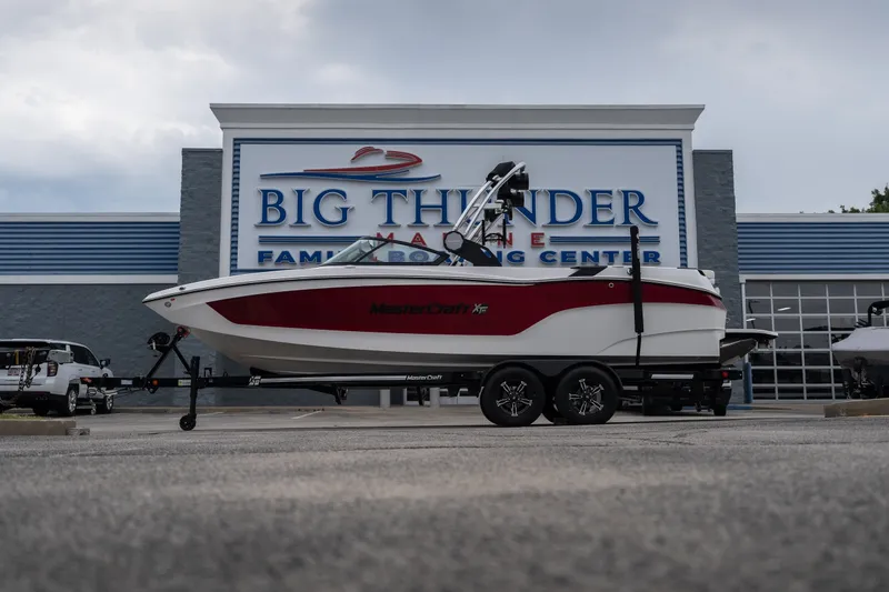 Slide: The Image of 2023 MasterCraft XT24 boat on trailer at Big Thunder Marine center. - 49