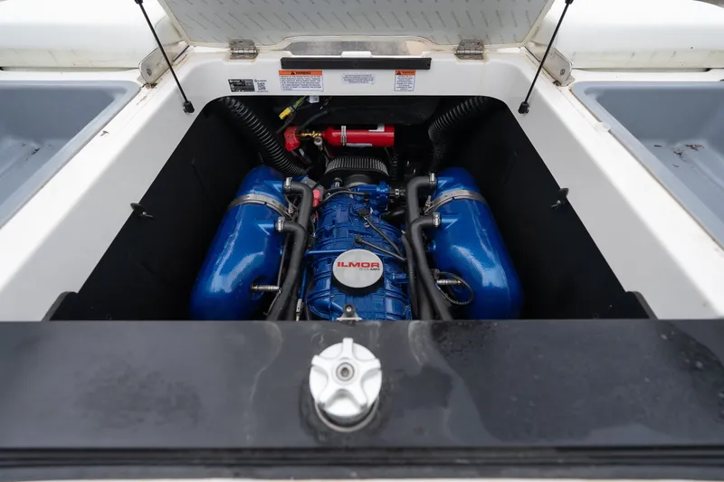 Slide: The Image of 2023 MasterCraft XT24 engine compartment with Ilmor engine, showcasing blue components and detailed engineering. - 30