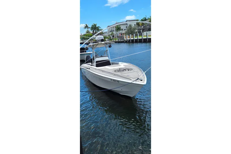Slide: The Image of 1997 Wellcraft 30 Scarab Sport boat docked on a sunny day, with clear blue skies. - 25