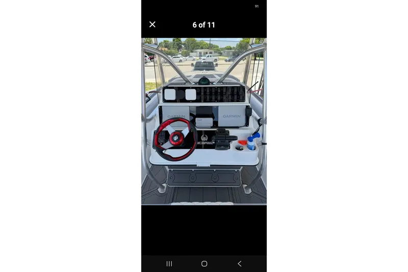 Slide: The Image of 1997 Wellcraft 30 Scarab Sport boat dashboard with Garmin navigation and red steering wheel. - 14