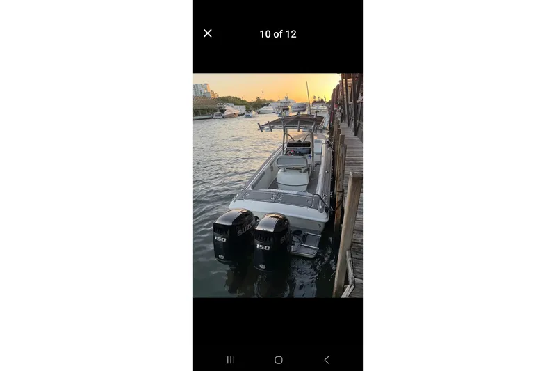 Slide: The Image of 1997 Wellcraft 30 Scarab Sport boat docked at sunset with dual Suzuki engines. - 22