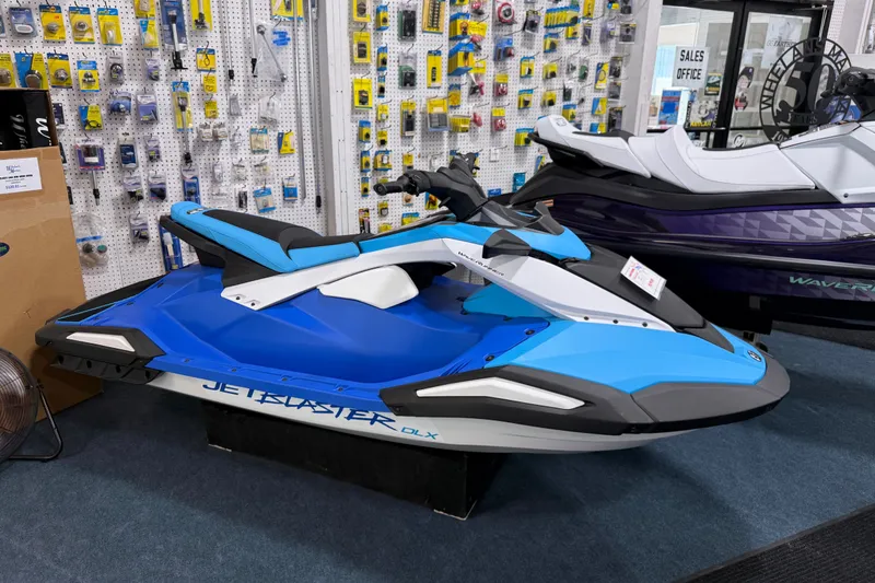 The Image of 2026 Yamaha WaveRunner JetBlaster DLX 3-Up in showroom, blue and white design. - 0