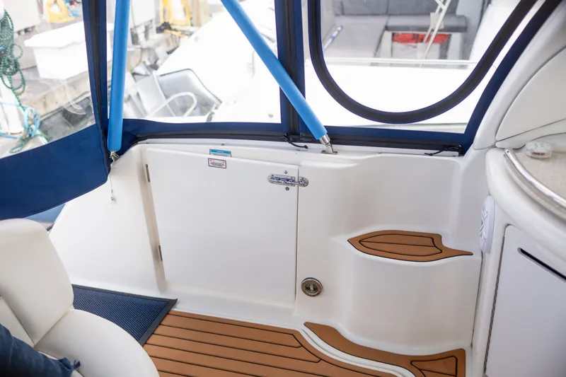 Slide: The Image of Interior view of 2005 Sea Ray 340 Sundancer boat with teak flooring and blue accents. - 11