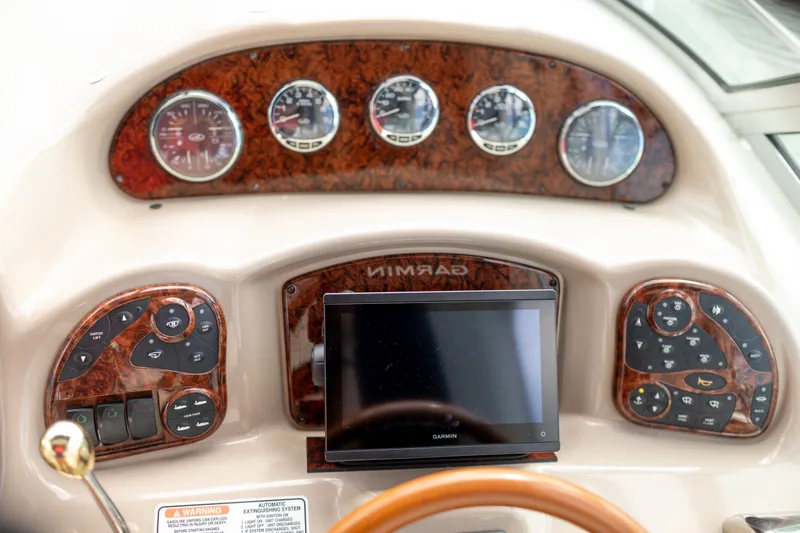 Slide: The Image of Dashboard of a 2005 Sea Ray 340 Sundancer with Garmin navigation system and woodgrain finish. - 14
