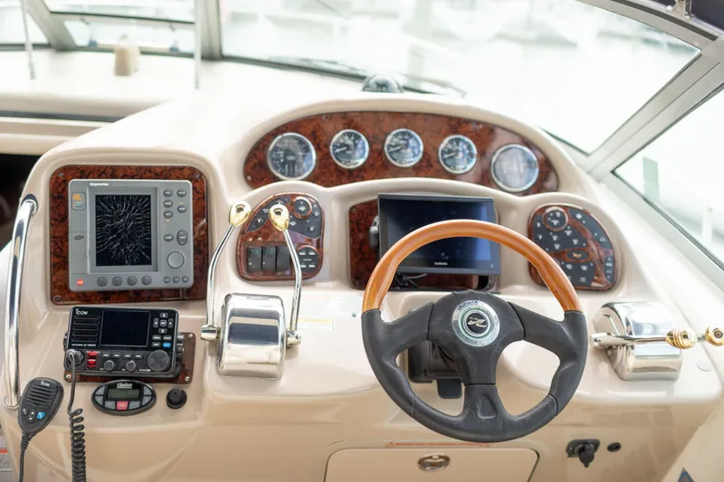 Slide: The Image of 2005 Sea Ray 340 Sundancer helm with navigation instruments and steering wheel. - 12