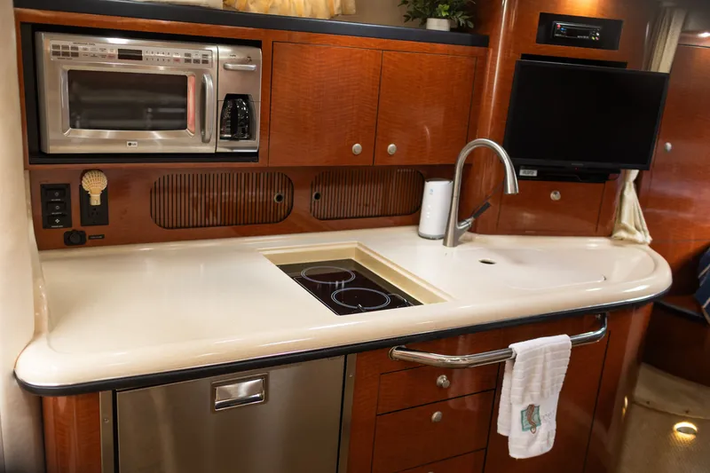Slide: The Image of Luxurious 2005 Sea Ray 340 Sundancer yacht kitchen with modern appliances and sleek design. - 20