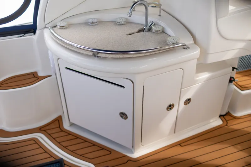 Slide: The Image of 2005 Sea Ray 340 Sundancer boat interior with sink and wooden flooring. - 9