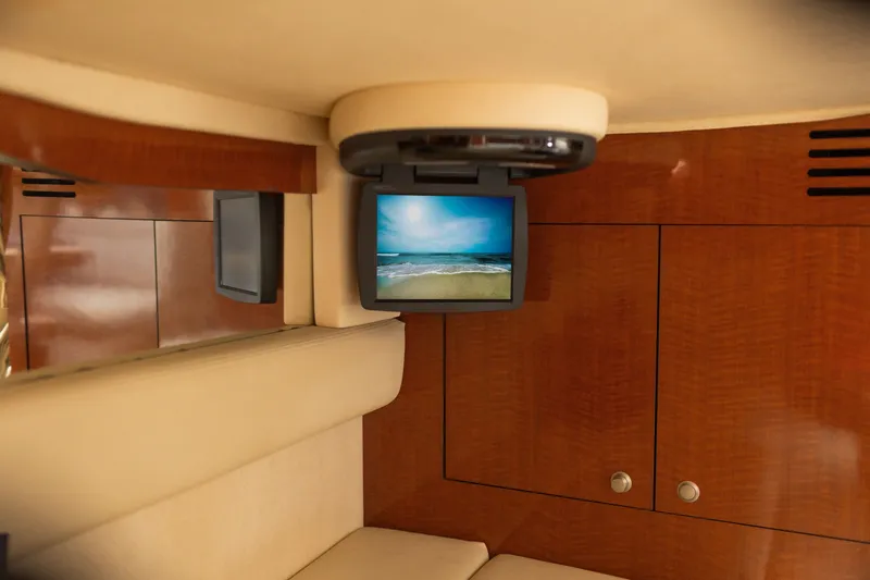 Slide: The Image of Interior of 2005 Sea Ray 340 Sundancer with TV and wooden cabinetry. - 17
