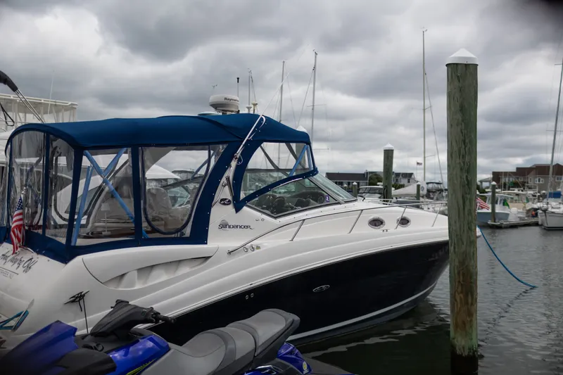 Slide: The Image of 2005 Sea Ray 340 Sundancer docked at marina under cloudy skies. - 26