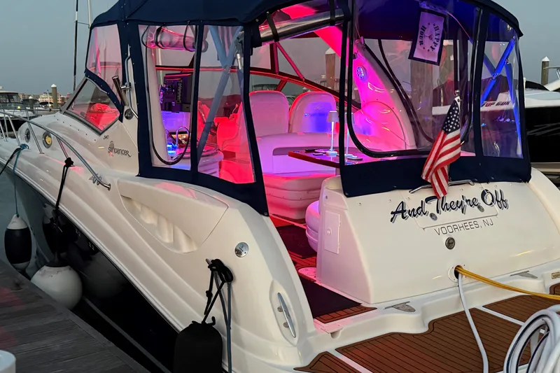 Slide: The Image of 2005 Sea Ray 340 Sundancer docked, illuminated with vibrant pink and blue lights. - 6