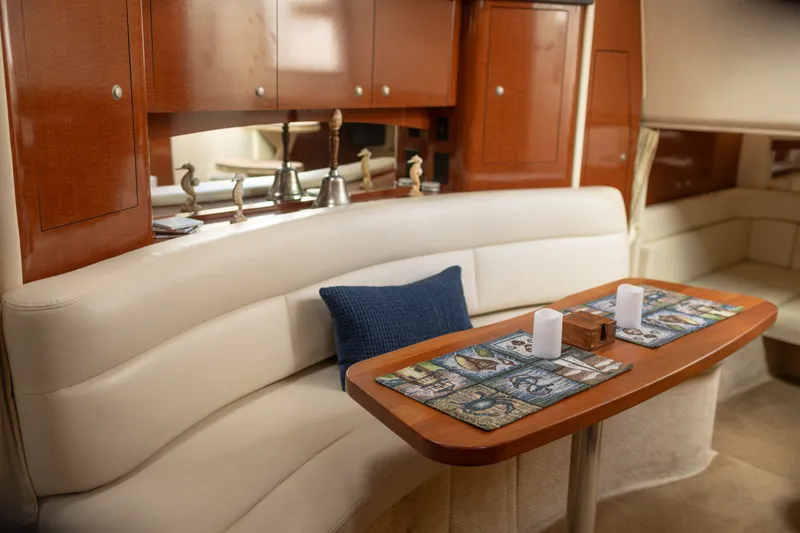 Slide: The Image of Interior of 2005 Sea Ray 340 Sundancer yacht with elegant seating and wooden cabinetry. - 15