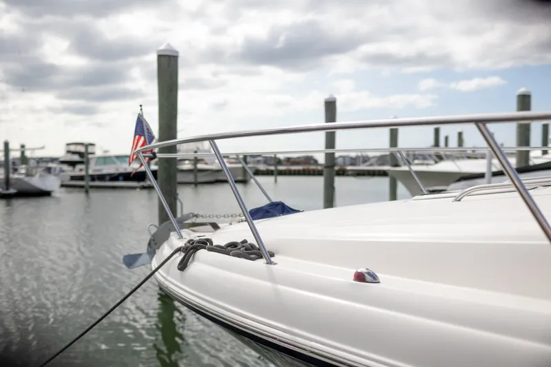 Slide: The Image of 2005 Sea Ray 340 Sundancer yacht docked at marina with American flag. - 4