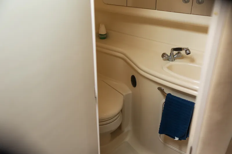 Slide: The Image of 2005 Sea Ray 340 Sundancer bathroom with sink, toilet, and towel. - 19