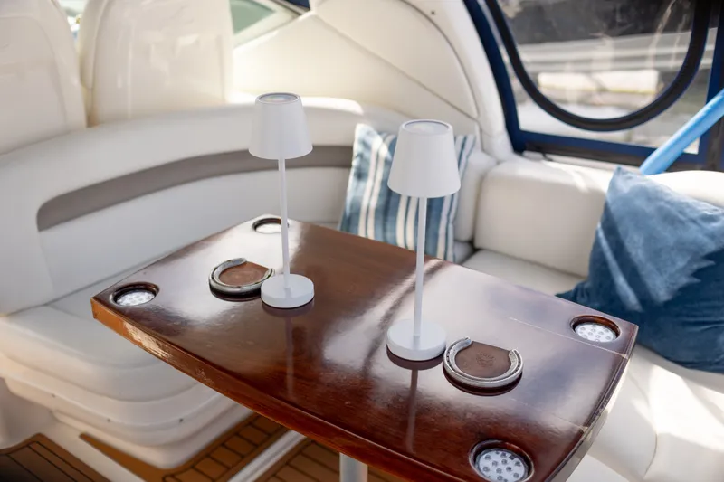 Slide: The Image of Interior of 2005 Sea Ray 340 Sundancer with elegant wooden table and cozy seating. - 10
