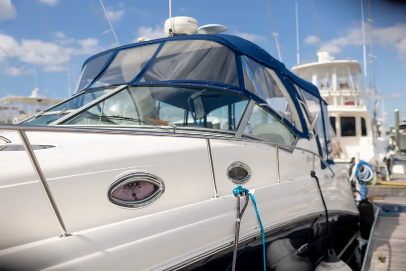 Slide: The Image of 2005 Sea Ray 340 Sundancer yacht docked at marina under blue sky. - 1