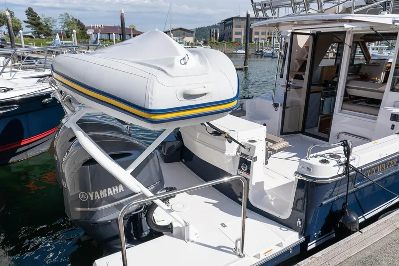 Slide: The Image of 2027 Cutwater C-32 CB boat with Yamaha motor and inflatable dinghy at marina. - 13