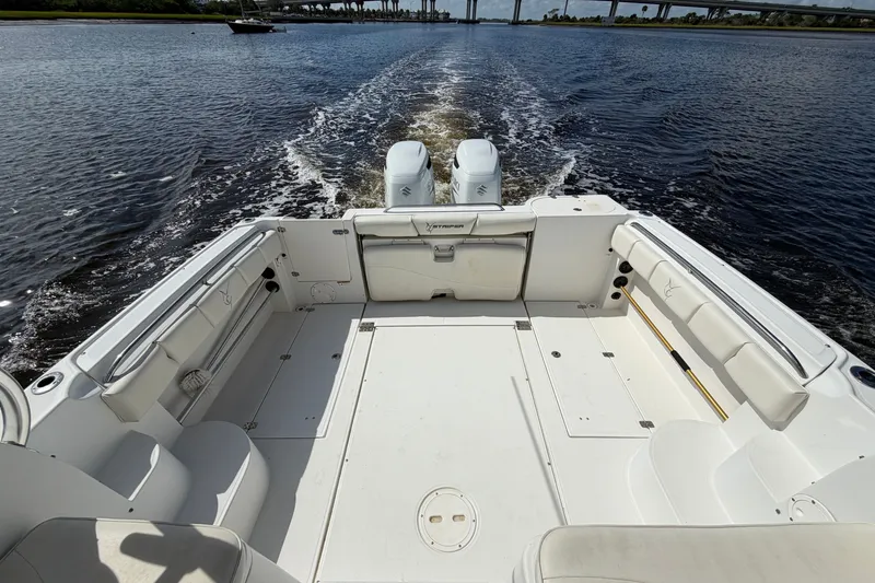 Slide: The Image of 2004 Seaswirl Striper 2901 Walkaround O/B cruising on open water, showcasing spacious deck. - 18