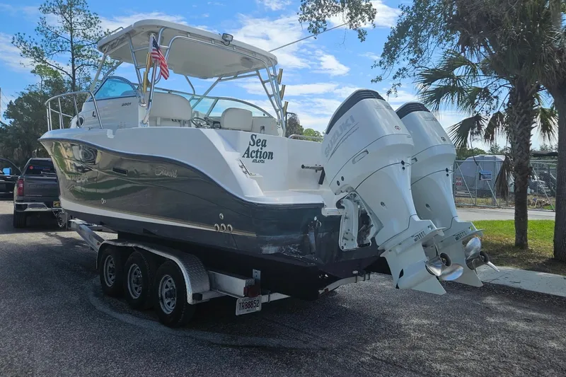 Slide: The Image of 2004 Seaswirl Striper 2901 Walkaround O/B boat on trailer with dual Suzuki outboard engines. - 34