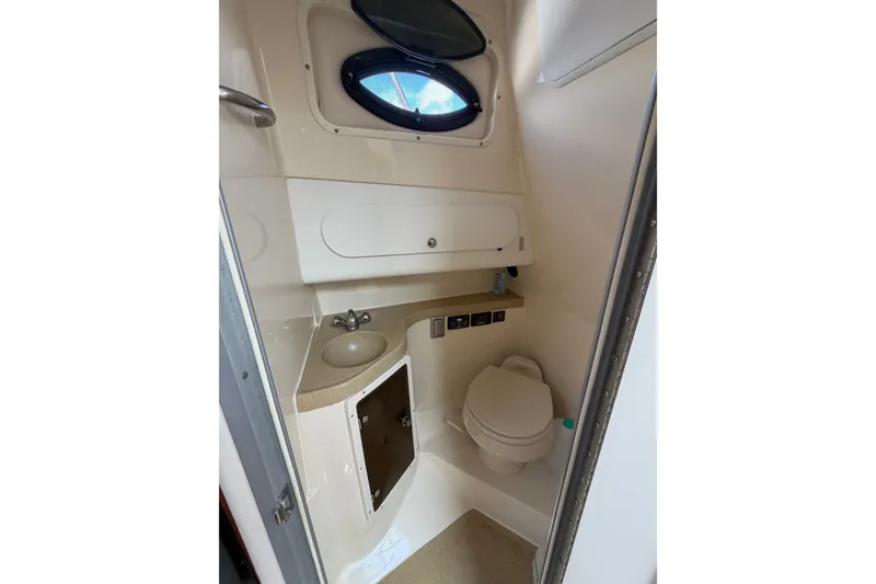 Slide: The Image of 2004 Seaswirl Striper 2901 Walkaround O/B boat bathroom with sink, toilet, and storage. - 31