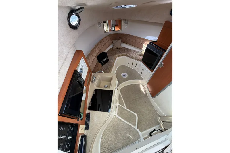 Slide: The Image of 2004 Seaswirl Striper 2901 Walkaround O/B cabin interior with kitchenette and seating area. - 29