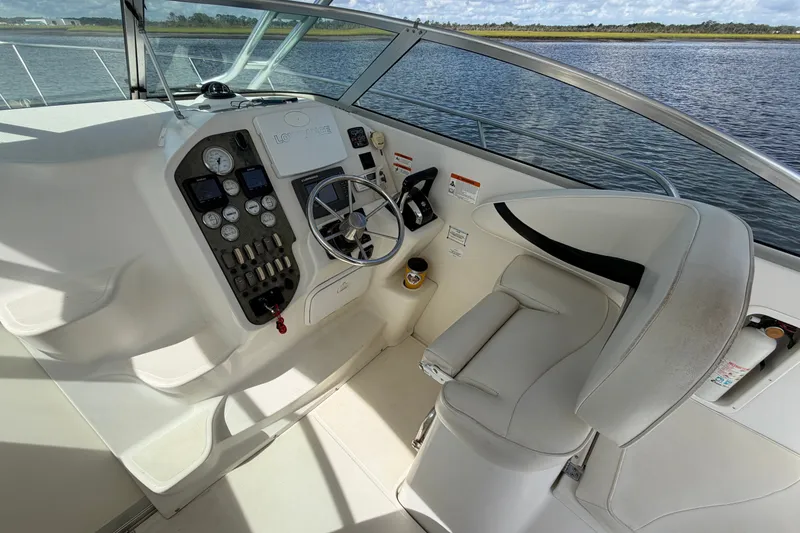 Slide: The Image of 2004 Seaswirl Striper 2901 Walkaround O/B helm with steering wheel and control panel. - 22