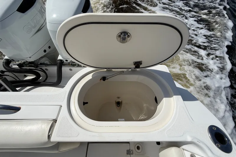 Slide: The Image of Open hatch on 2004 Seaswirl Striper 2901 Walkaround O/B boat, showing storage compartment. - 21