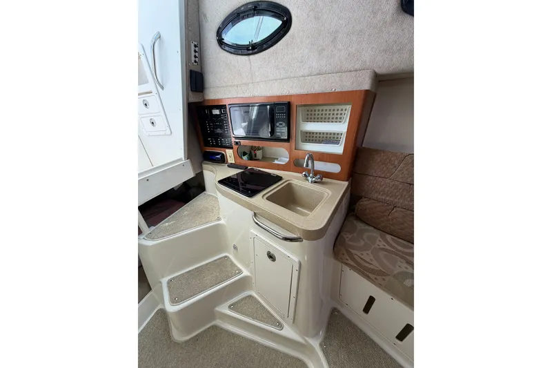 Slide: The Image of 2004 Seaswirl Striper 2901 Walkaround O/B cabin interior with kitchenette and seating area. - 30