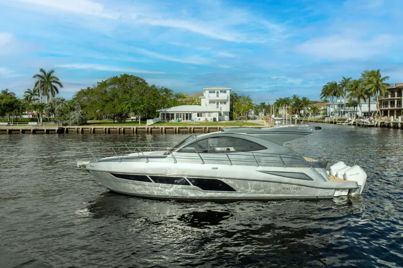 Slide: The Image of 2025 Valiatt 410HT luxury yacht cruising on a scenic waterfront with palm trees. - 21
