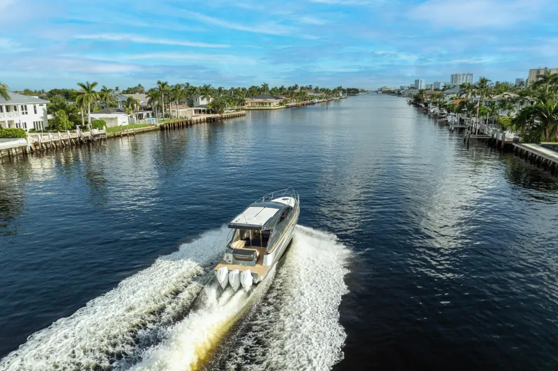 Slide: The Image of Valiatt 410HT 2025 cruising on a scenic waterway with palm trees and blue sky. - 15