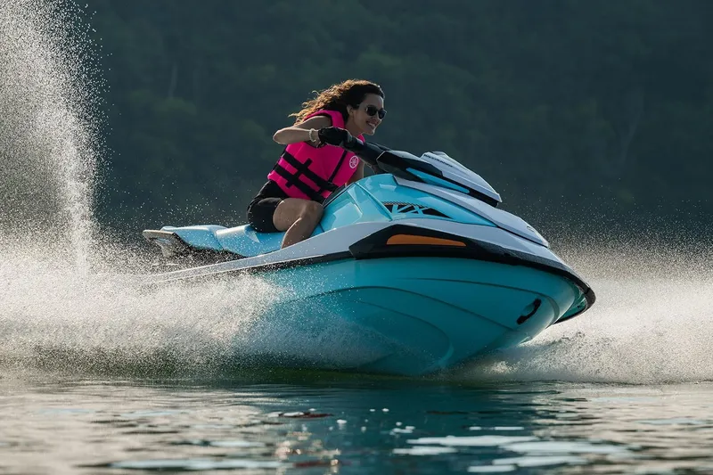 Slide: The Image of Manufacturer Provided Image: 2026 Yamaha WaveRunner VX jet ski speeding on water, rider wearing pink life vest. - 2