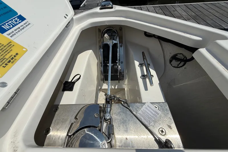 Slide: The Image of Anchor compartment of 2026 Pursuit S 268 Sport boat, featuring stainless steel hardware. - 15