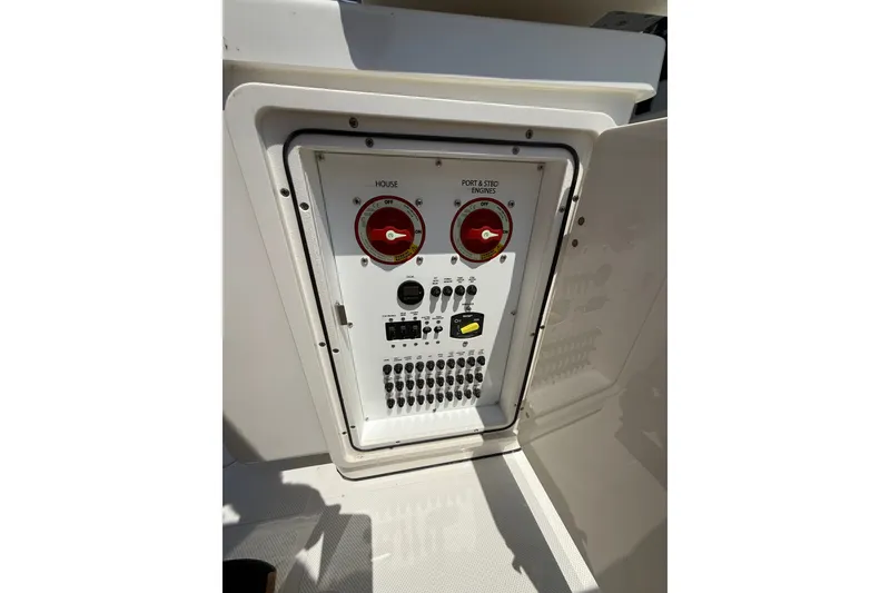 Slide: The Image of Electrical panel of 2026 Pursuit S 268 Sport boat, featuring switches and controls. - 13