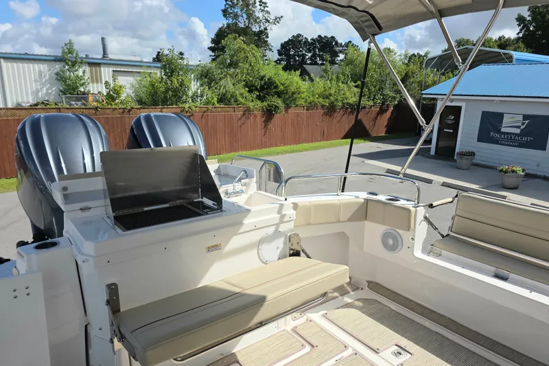 Slide: The Image of 2027 Cutwater C-32 Coupe boat interior with seating and dual outboard engines. - 3