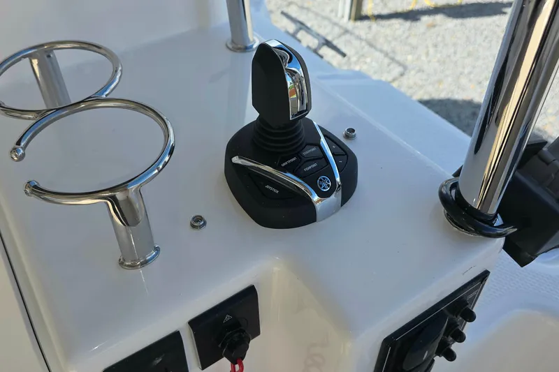Slide: The Image of Joystick control on 2027 Cutwater C-32 Coupe boat dashboard, featuring chrome cup holders. - 5