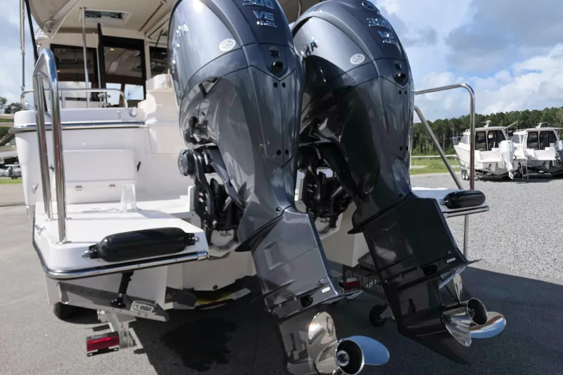 Slide: The Image of 2027 Cutwater C-32 Coupe with dual outboard engines, docked on a sunny day. - 32