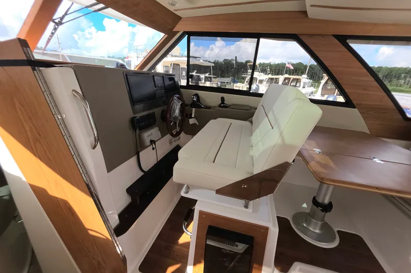 Slide: The Image of Interior of 2027 Cutwater C-32 Coupe, featuring helm station and seating area. - 22