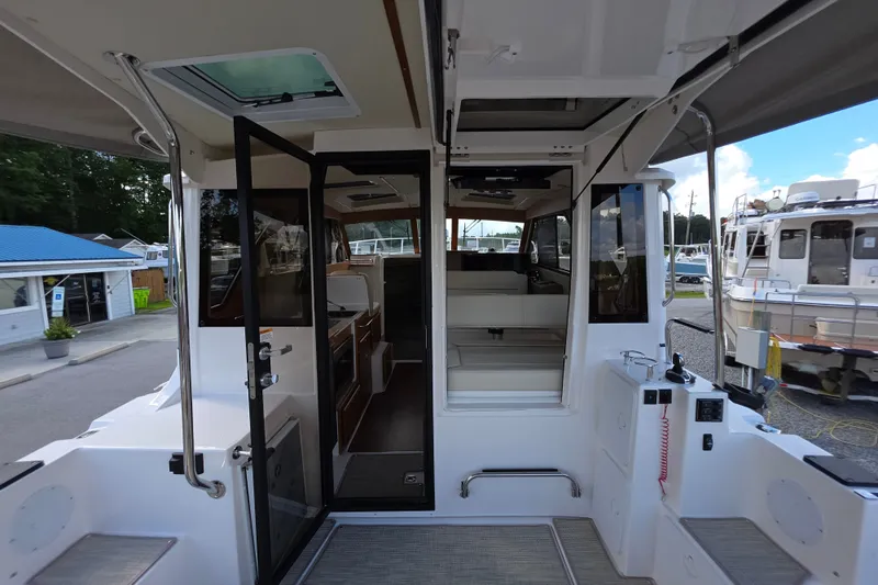 Slide: The Image of Interior view of 2027 Cutwater C-32 Coupe boat, showcasing seating and cabin entrance. - 9