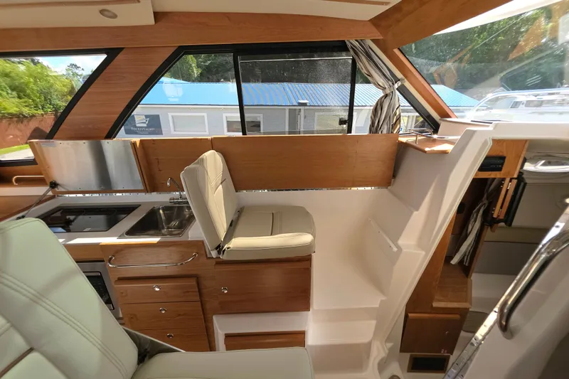 Slide: The Image of Interior of 2027 Cutwater C-32 Coupe, featuring modern kitchen and seating area. - 21