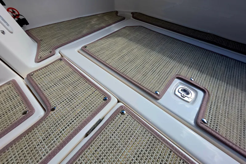 Slide: The Image of 2027 Cutwater C-32 Coupe interior flooring with textured mats and secure hatch. - 8