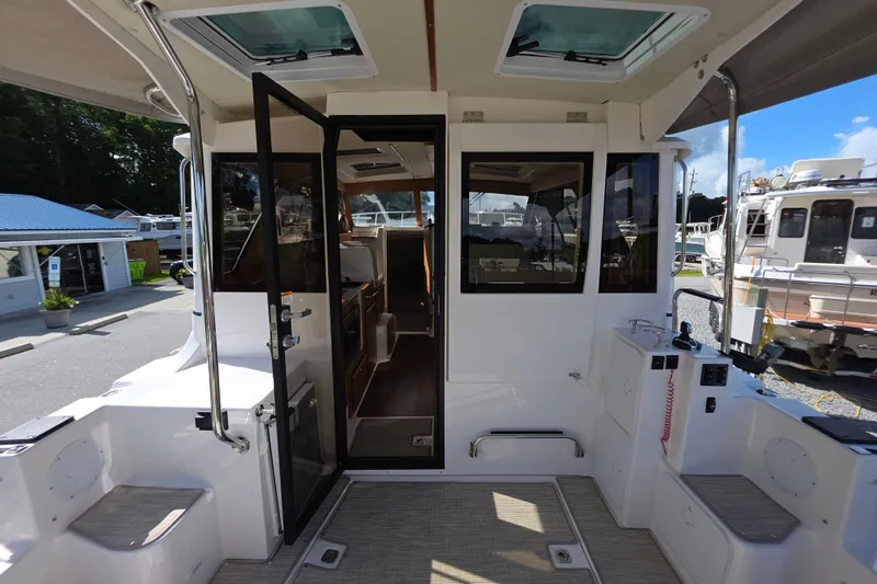Slide: The Image of 2027 Cutwater C-32 Coupe boat interior with open door and seating area. - 7